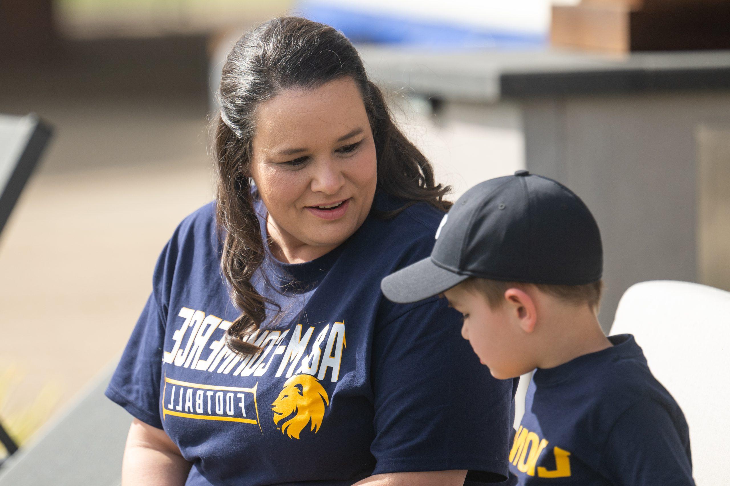 A staff speaking with a child about event taking place.